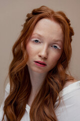Naklejka premium Fashion Portrait of redhead young woman with white extended eyelashes and wavy hair. Concept romantic makeup skin care