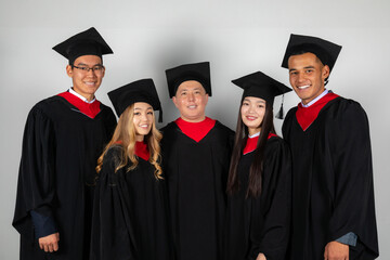 Group of graduate students friends pose together excitedly