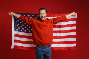 Young bristle man smiling while posing american flag