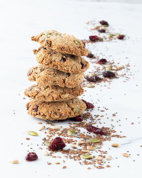 A Stack Of Trail Mix Cookies With A Trail Of The Mix In Behind. 