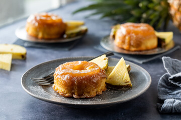Freshly baked mini pineapple upside down cakes with caramel sauce on top.
