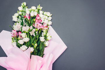 Women's day background. Bouquet of white and pink eustoma and alstroemeria flowers. Present gift for Mother's day. Space