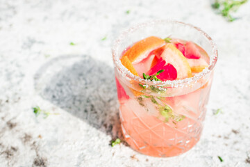 Grapefruit drinks with ice cubes and thyme