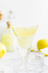 Italian traditional liqueur limoncello with lemon