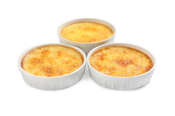 Delicious creme brulee in ceramic ramekins on white background