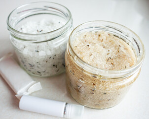 Sea salt and body scrub in a glass jar. Natural spa body cosmetics for the body on white background	