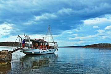 Fototapeta na wymiar Greece-view of the boat by the coast near Vivari