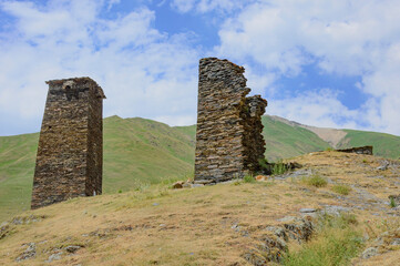 Ushguli fortified village in Svanetia, Georgia. Grey, brown and biege medieval stone towers left...