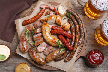 Set of different tasty snacks and beer on wooden table, flat lay