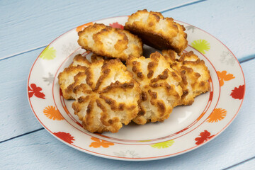 Homemade coconut cookies on plate on table