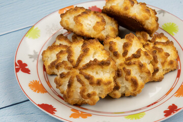 Homemade coconut cookies on plate on table