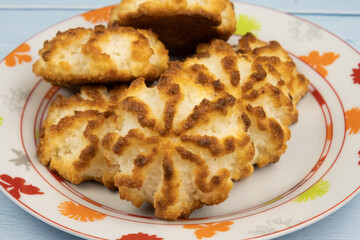 Homemade coconut cookies on plate on table