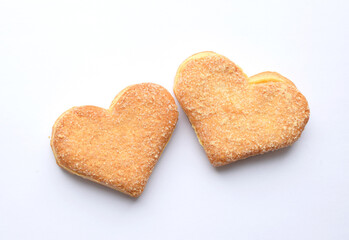 Two biscuits in sugar in the shape of a heart on a white background. Valentine's day concept