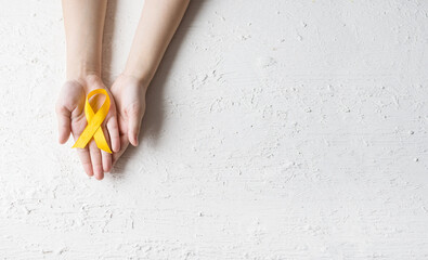 International Childhood Cancer Day. Baby holding yellow ribbon. Sarcoma Awareness, bladder cancer....