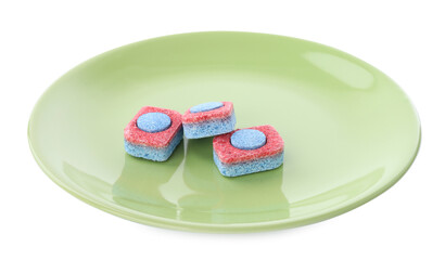 Green plate with dishwasher detergent tablets on white background