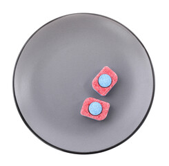 Grey plate with dishwasher detergent tablets on white background, top view