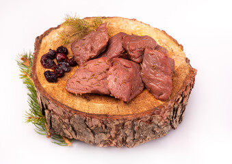 Raw game meat, beef on chopping block, wood slice, isolated. Steaks, pieces of red meat, roe deer meat on wood.