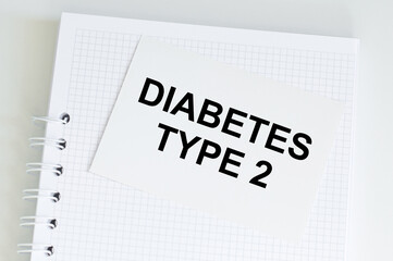 text diabetes TYPE 2 on a card with a white notepad on the table, medical concept