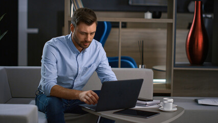 Financial manager using computer in office. Businessman finishing work indoors.