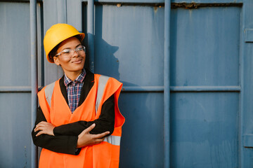 Black woman wearing helmet smiling while working outdoors