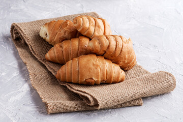 fresh croissants with chocolate filling on burlap
