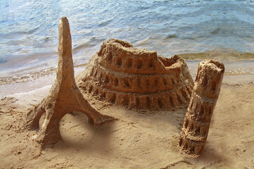 Travel around the world. Famous landmarks made of sand - Coliseum, Eiffel tower, Pisa tower, sand castles. Travel concept