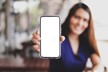 Close up of women show blank display of smart phone in restaurant 