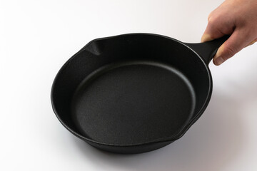 Cast iron frying pan on a white background