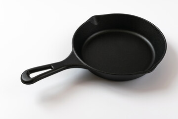 Cast iron frying pan on a white background
