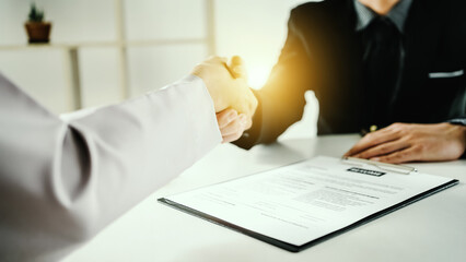 Young businessman and businesswoman shake hands, Man holding hands with internship in office