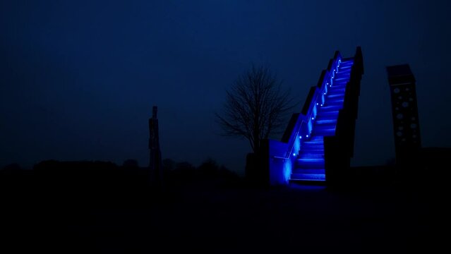 Stairway to heaven at night. Blue illuminated stairs outside in nature