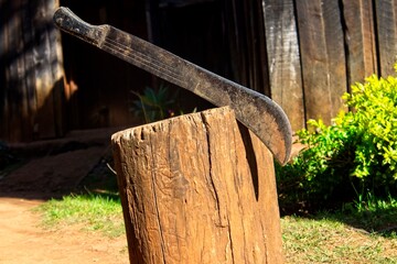 A machete cutting a log