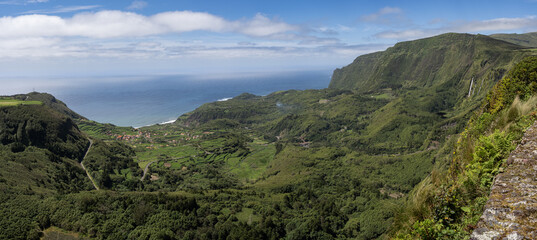 Fototapeta na wymiar Overview of the spectacular and green valley where Fajãzinha is located, from the Craveiro Lopes viewpoint. Lajes das Flores, Flores Island.