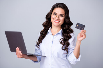Naklejka premium Photo of confident banker lady hold netbook debit card wear glasses blue shirt isolated grey color background