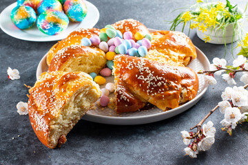 Traditional Italian Easter bread rings, decorated with eggs and colorful sprinkles