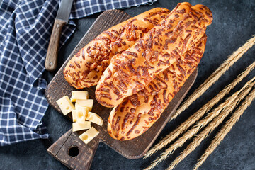Bread and cheese sticks on a dark background