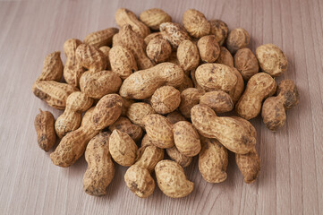 Peanuts in shell on wooden background