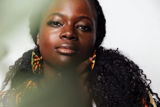 Young curvy woman with makeup and african accessories