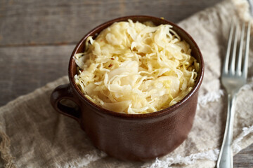 Fermented cabbage or sauerkraut on a table, with copy space