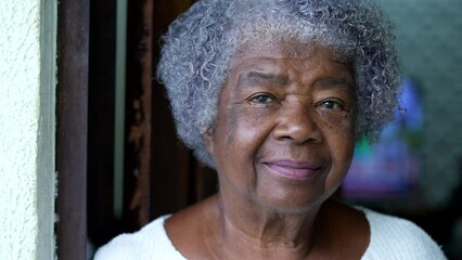 Portrait of a senior black woman face close-up looking at camera - Powered by Adobe