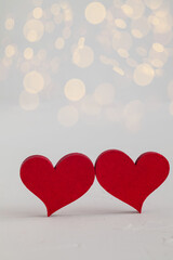 Two red wooden hearts on a white background. Copy space. Valentine's Day concept.