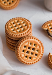 Sweet sandwich cookies with chocolate cream on a white table. Sandwich cookies close up.