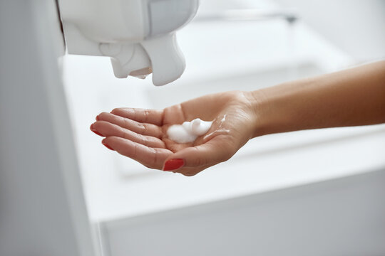 Woman use soap and washing hands under the water tap. Hygiene concept hand