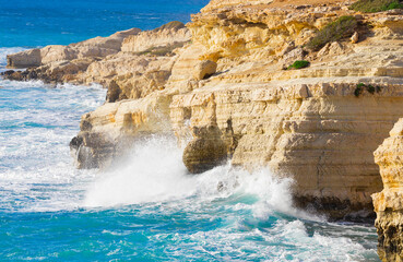 Ocean waves splash against beach with rocks background, Cliffs in the sea, Top aerial view of Cyprus, Nature Background with Sea, Vacation and relax