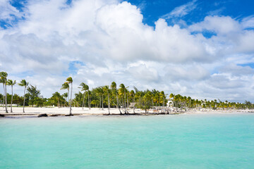 Juanillo beach with palm trees, white sand and turquoise caribbean sea. Cap Cana is a tourist area in Dominican Republic. Aerial view