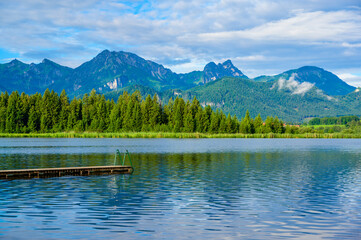 Fototapeta na wymiar Lake Hopfensee near Fuessen - View of Allgaeu Alps, Bavaria, Germany - paradise travel destination