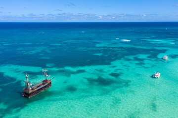 Pirate ship floating in caribbean sea. It is popular tour for tourists. Dominican Republic. Aerial view