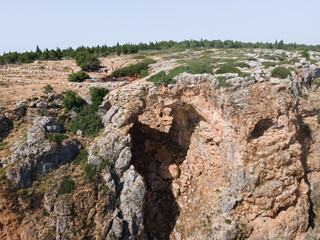 Fototapeta na wymiar The Keshet Cave - ancient natural limestone arch spanning the remains of a shallow cave with sweeping views near Shlomi city in Israel