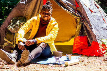 african american man in yellow jacket with a hood and dreadlocks pigtails