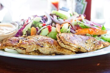 Chicken and salad on a plate ready to be eaten